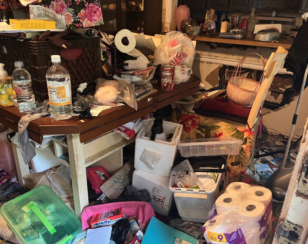 Packed table and household items for Berkley hoarding cleanup sorting